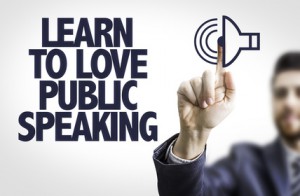 Business man pointing the text: Learn to Love Public Speaking